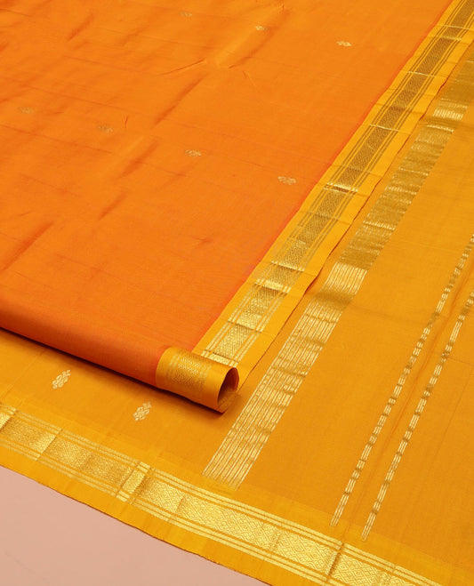 Orange Kanchipuram Silk Saree, Bedecked with Zari Buttas on Its Body, Complemented by a Contrast Zari One-Sided Border of Banaras, and Jaal Designs, Pallu of Zari Designs, and Comes Without a Blouse