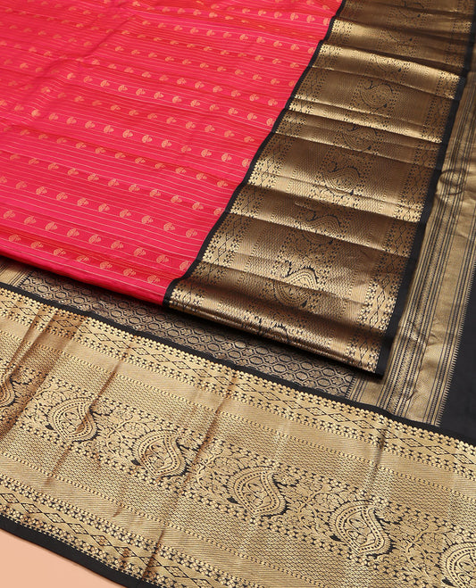 Red Vasundhara Silk Saree, Subtly Sparkled with Buttas and Stripes All Over Its Body, Complemented by Contrast Zari Border of Diamond, Mayil Kann, Manga, and Kodi Visiry Designs, Opulently Embellished Pallu, and Paired with a Contrast Blouse