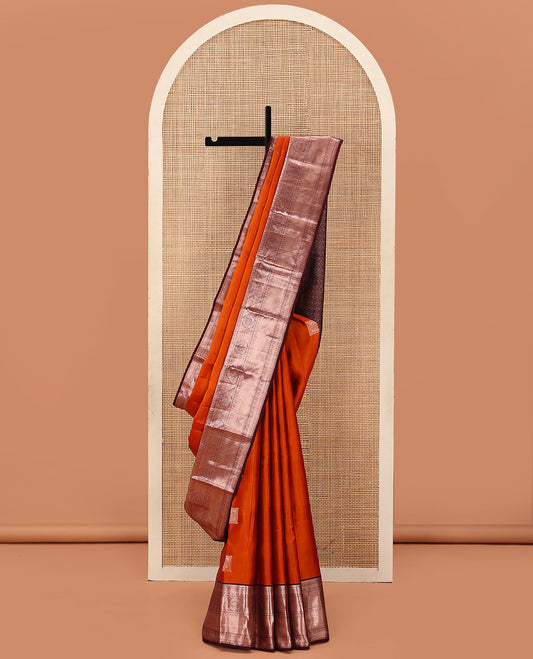 Orange Vasundhara Lite Silk Mix Saree Decorated with Zari Buttas, Complemented with a Contrast Border Featuring Chakram, Rudraksham, Vanki, Kathir, and Lavangam Designs, Zari Elevated Jaal Pallu, and Paired with a Contrast Blouse