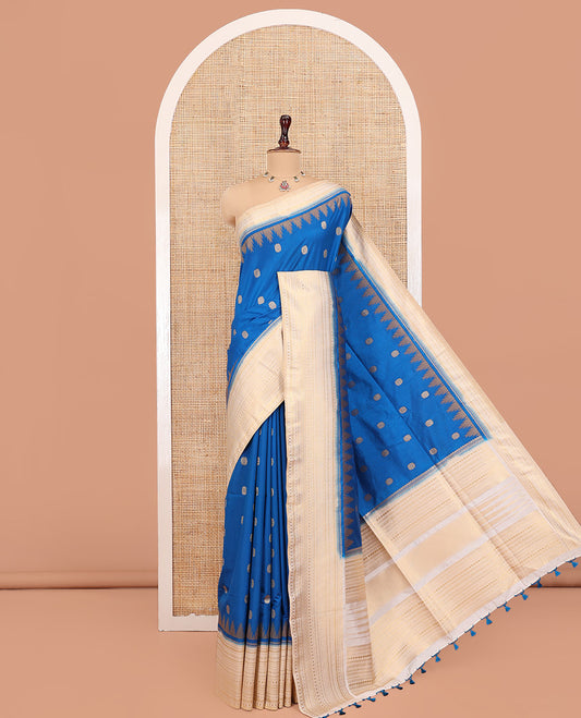 Peacock Blue Dupion Silk Saree, Ornamented with Zari Buttas All Over Its Body, Complemented by a Contrast Temple Traditional Zari Design Woven Border, Traditional Pallu of Temple Designs, and Paired with a Contrast Blouse