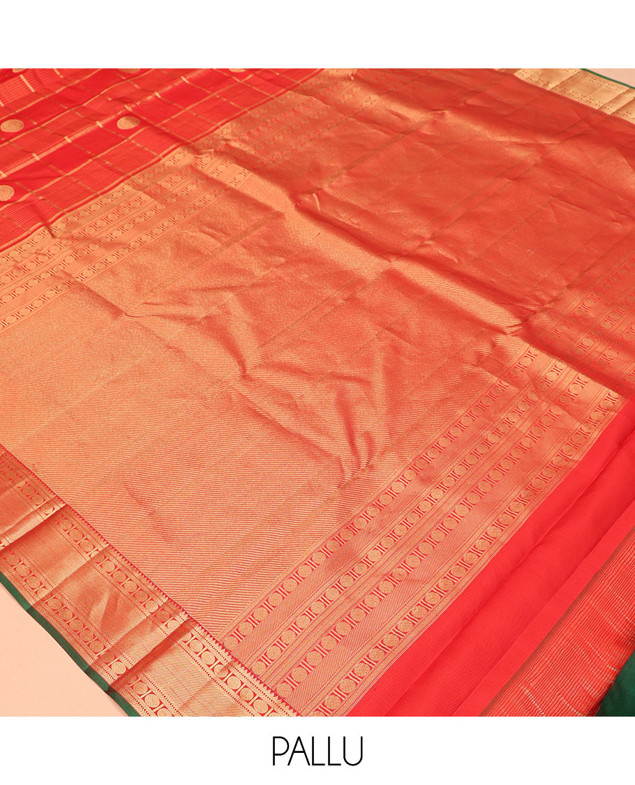 Red Vasundhara Silk Saree, Spotlighted with Chakram Buttas and Checks, a Zari Border of Rekku, and Chakram Designs, a Gleamed Up Pallu, and a Contrast Blouse