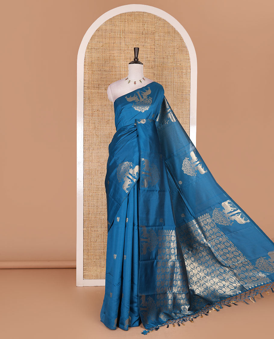 Borderless rama blue peacock, chakra, and pichwai cow buttas zari woven kanchi silk saree, peacock and chakra enclosed checked pallu, and matching blouse