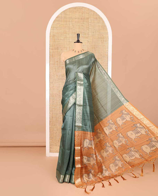 Green striped semi-tussar saree, traditional zari border of floral creeper designs, contrast pallu of Pichwai cow print, and contrast Pichwai cow printed blouse