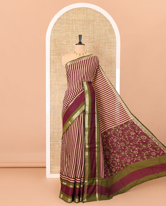Wine vertically striped muslin silk saree, contrast zari rettai pettu border, kalamkari floral vine printed pallu, and a contrast plain blouse