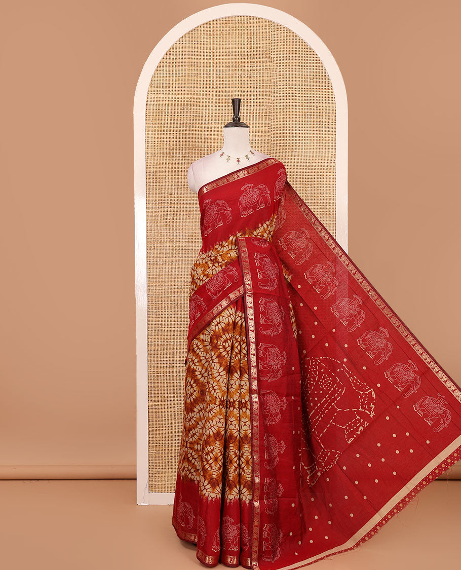 Mustard diamond patterns Shibori-style printed muslin cotton saree, contrast elephant motifs printed border, batik elephant motifs pallu & contrast flower buttas printed blouse