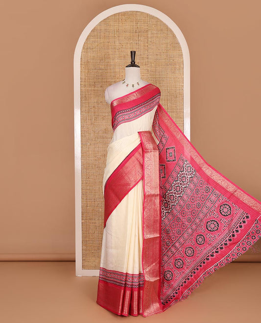 Cream-rani pink zari striped dola silk saree, contrast traditional zari border of leaf creeper, Ajrakh printed pallu, and Ajrakh printed blouse