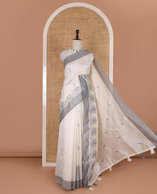 Half-white flower and flower pots motifs thread embroidered semi-tussar saree, contrast grey border, flower motif embroidered pallu, and a matching blouse