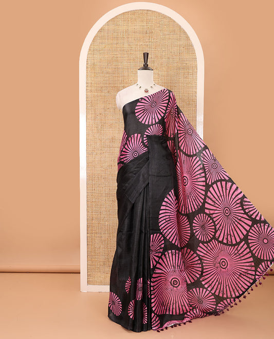 Black-base plain body khadi cotton saree with batik-style pink-color radiant sunburst design on its border & pallu, plain black blouse
