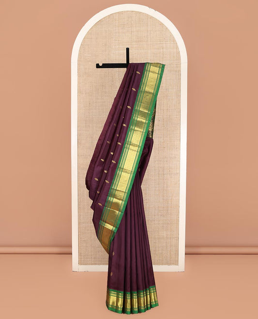 Maroon Kanchipuram Silk Saree, Spotlighted with Zari Buttas on Its Body, Complemented by a Contrast One-Sided Border of Panner Sombu, Banaras, and Jaal Designs, Pallu Features Floral Zari Designs, and Comes Without a Blouse