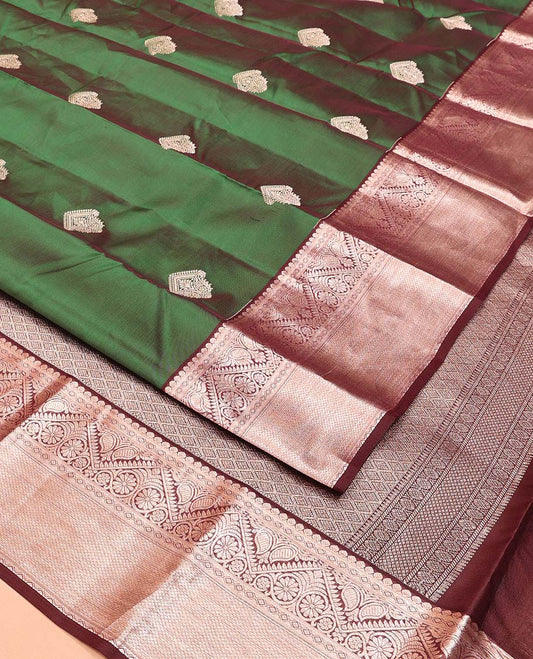 Green Vasundhara Lite Silk Mix Saree, Masterfully Woven with Zari Buttas All Over Its Body, Complemented by a Contrast Border of Thilakam, Diamond, Kodi Visiry, and Mayil Kann Designs, Grand Jaal Pallu, and Paired with a Contrast Blouse