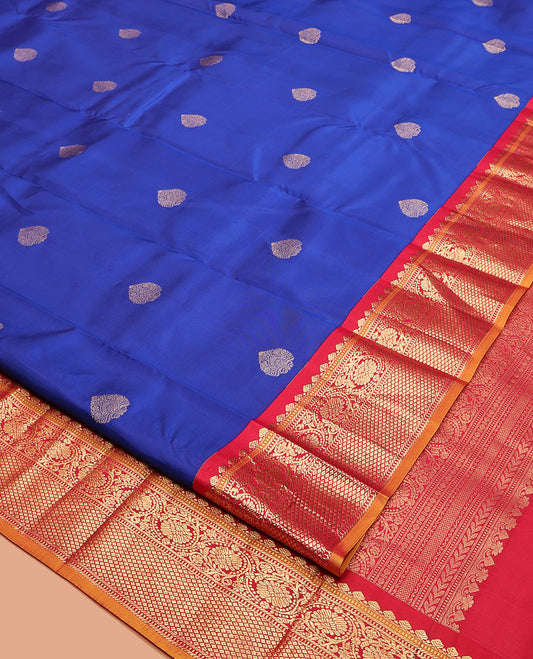 Royal Blue Vasundhara Silk Saree, Decorated with Zari Buttas, a Contrast Border of Thilakam Mokku, Muthu, Banaras, Kodi Visiry, and Mayil Kann Designs, Grand Pallu, and a Contrast Blouse