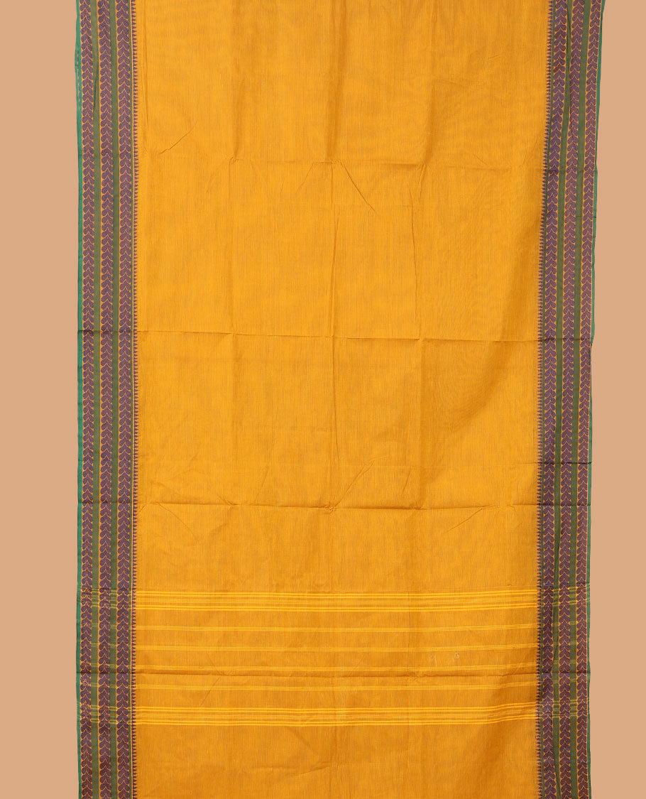 Yellow plain nine-yard cotton saree, temple border of leaf creeper designs, and striped pallu