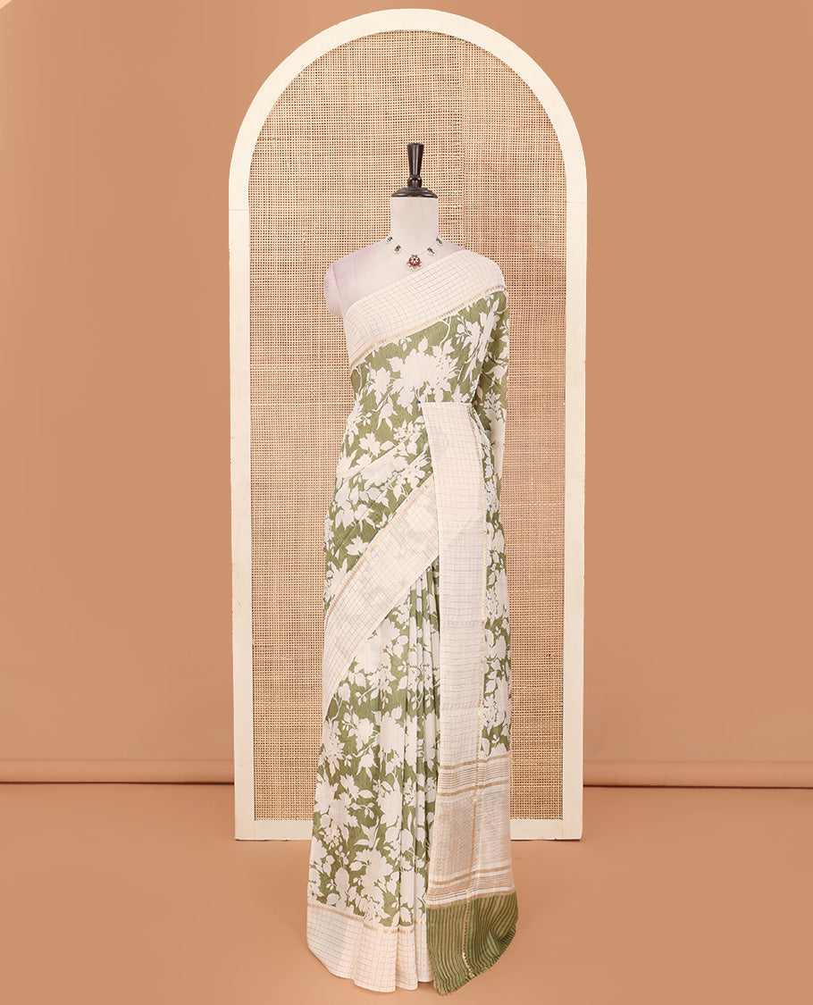 Light olive green silhouettes floral printed Muga silk saree, contrast temple zari checked border, and zari striped pallu