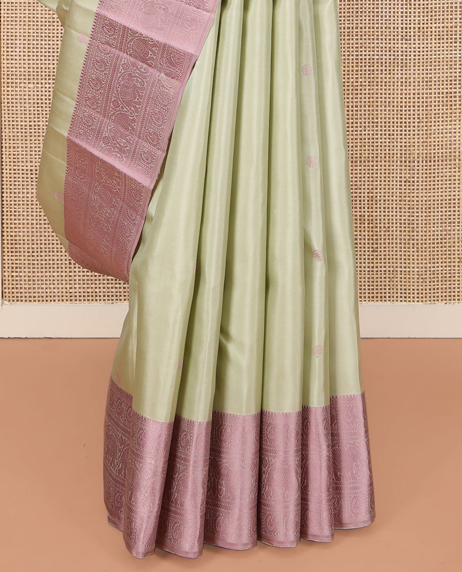 Green Kanchipuram Silk Saree, Subtly Enriched with Mayil-Chakram Buttas All Over Its Body, Complemented by a Contrast Border of Thilakam, Banaras, Mayil, Kathir, and Yaanai Designs, Pallu Steeped with Kamalam Designs, and Paired with a Contrast Blouse