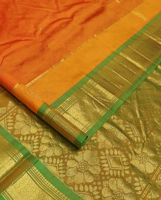 Orange Kanchipuram Silk Saree, Embellished with Zari Buttas All Over Its Body, Complemented by Contrast One-Sided Border of Panner Sombu, Banaras, Muthu and Jaal Designs, Pallu Features Floral-Diamond Designs, and Comes Without a Blouse