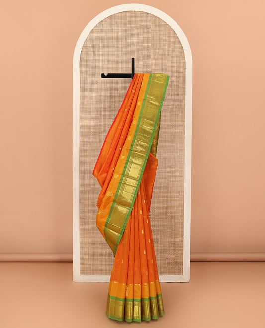 Orange Kanchipuram Silk Saree, Embellished with Zari Buttas All Over Its Body, Complemented by Contrast One-Sided Border of Panner Sombu, Banaras, Muthu and Jaal Designs, Pallu Features Floral-Diamond Designs, and Comes Without a Blouse