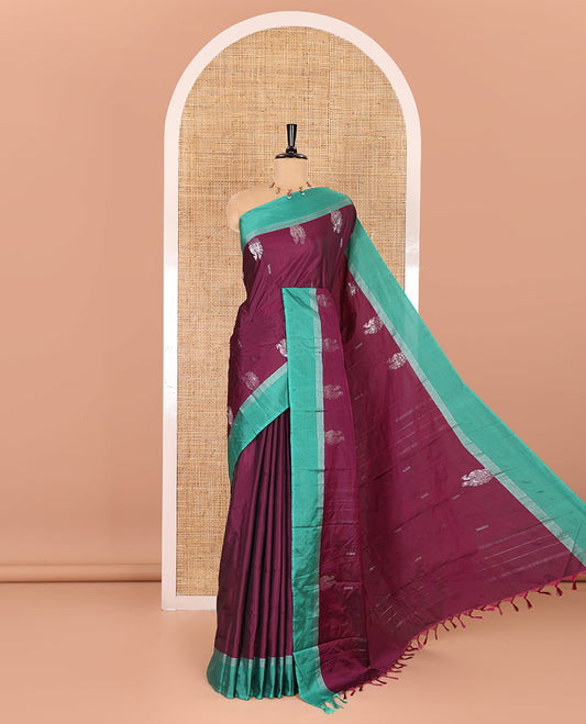 Purple dobby and peacock buttas semi-soft silk saree, contrast zari striped border, zari buttas pallu, and a matching blouse