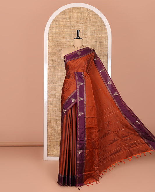 Rust orange buttas woven saree with contrast traditional temple border, and zari striped pallu