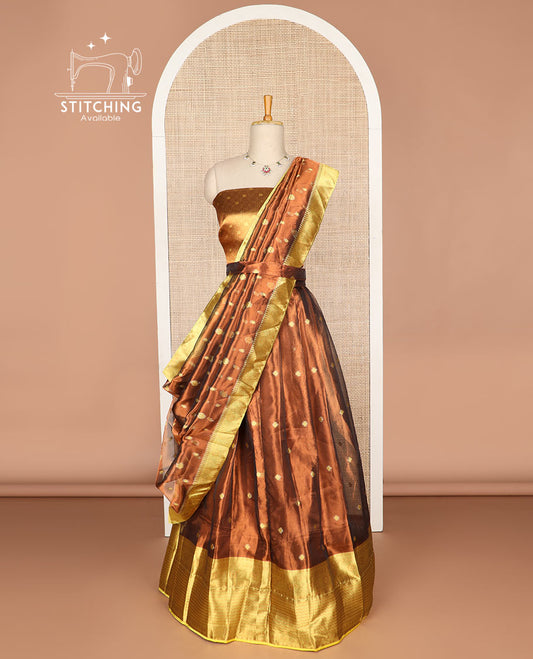 Rust color buttas tissue half saree with contrast zari design border, zari design blouse & floral design dhavani