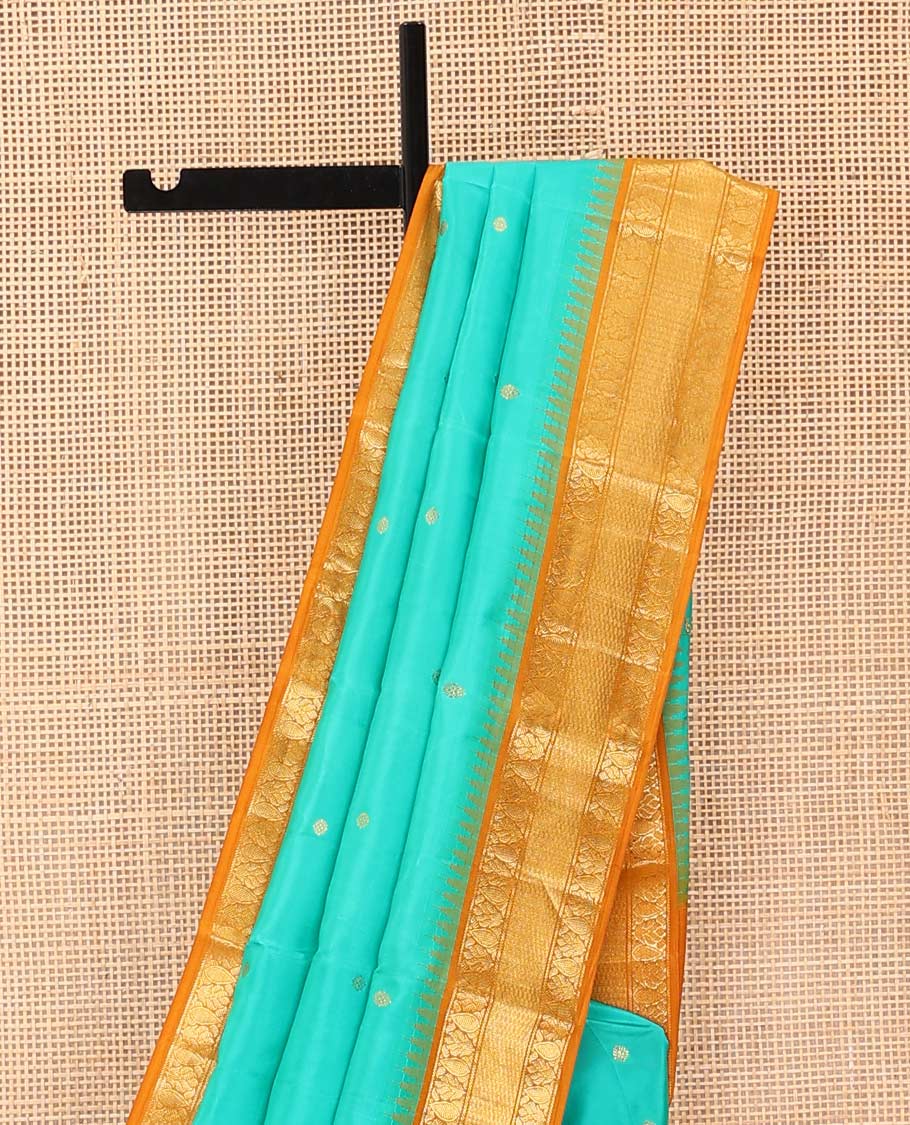 Turquoise buttas Bangalore silk saree, contrast temple traditional zari border, and pallu of jaal designs