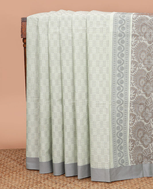 Pastel green buttas Kanchi cotton saree, contrast border, and pallu of floral and leaf design