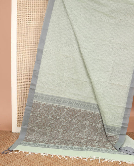 Pastel green buttas Kanchi cotton saree, contrast border, and pallu of floral and leaf design