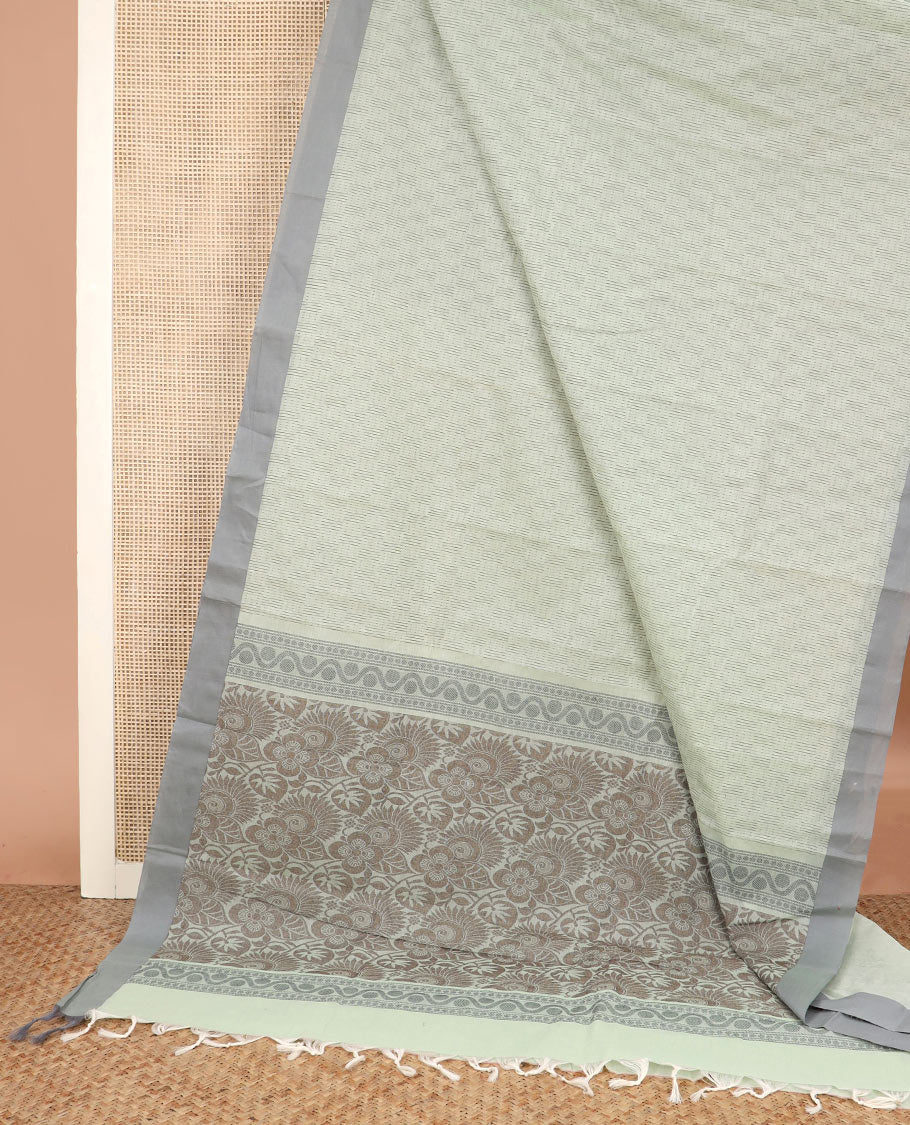 Pastel green buttas Kanchi cotton saree, contrast border, and pallu of floral and leaf design