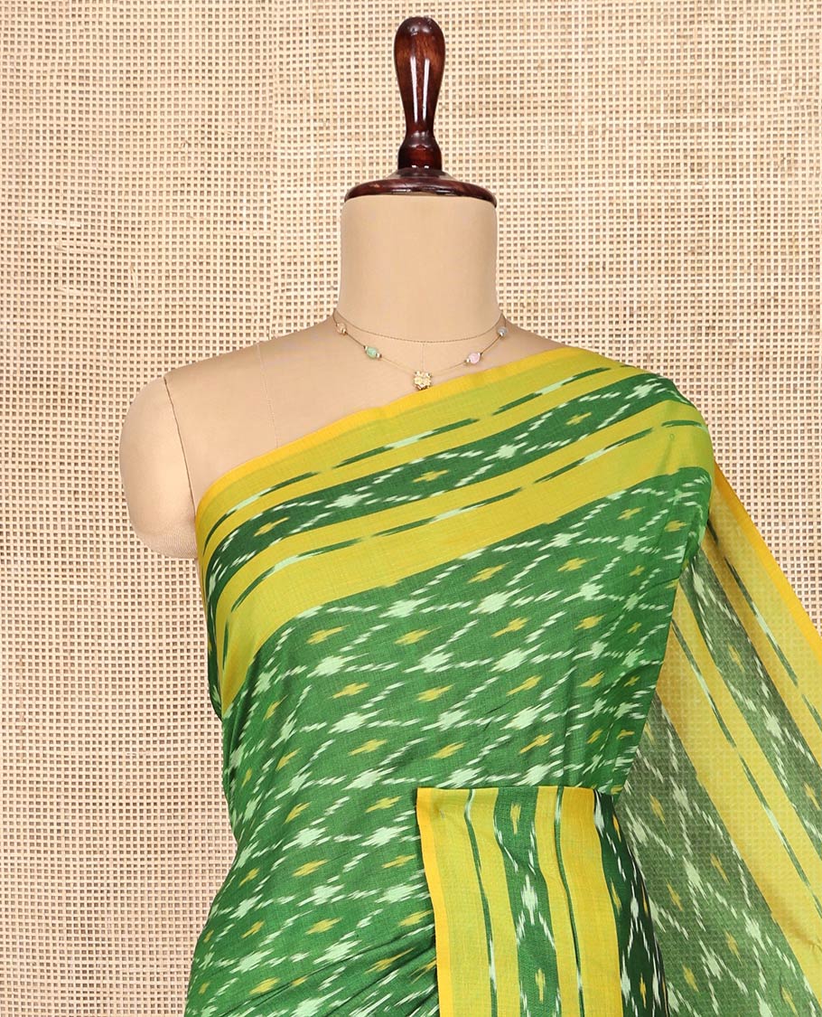 Green Ikkat Cotton Saree, Ornamented with Ikkat-Style Jaal-Patterns on Its Body, Complemented by Contrast Ikkat Border, Pallu of Jaal Designs, and Has No Blouse