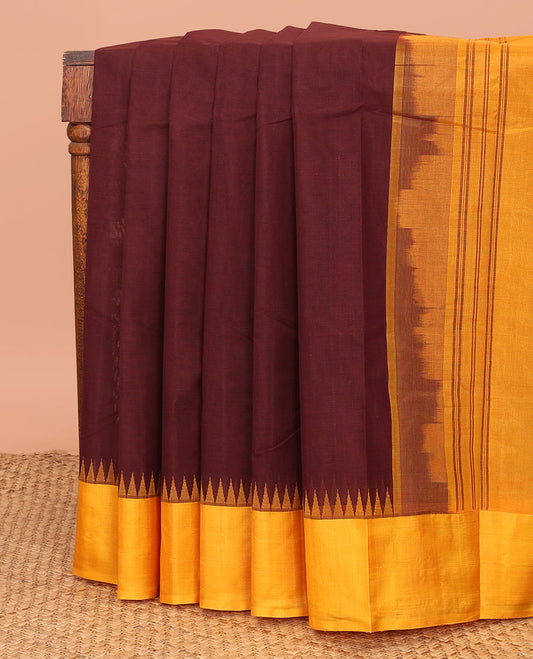 Brown Plain Kanchi Cotton Saree, Complemented by a Contrast Temple Border, Subtly Striped Pallu, and Paired with a Contrast Blouse