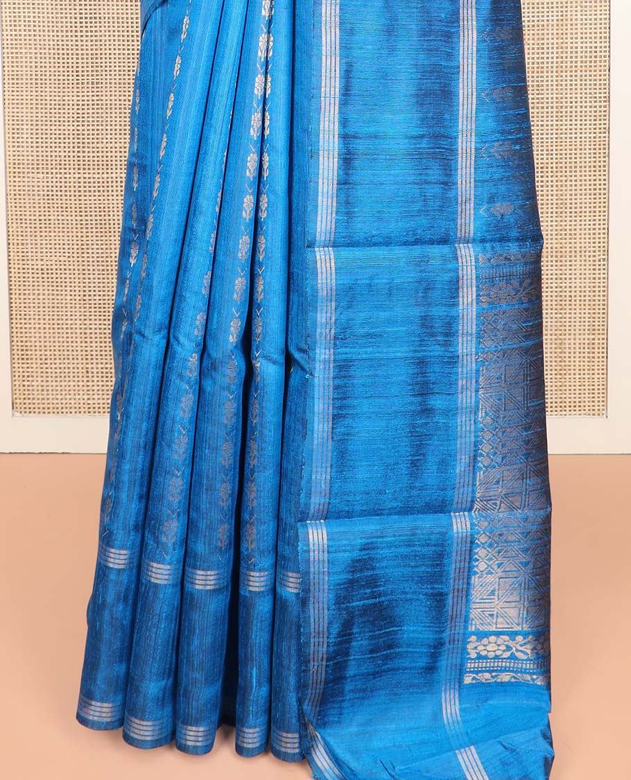 Blue Dupion Silk Saree, Graced with Floral Buttas All Over Its Body, Complemented by a Zari Striped Border, Sparsely Woven Pallu of Intricate Geometric Patterns, and Paired with a Matching Blouse