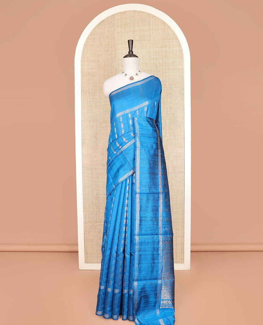 Blue Dupion Silk Saree, Graced with Floral Buttas All Over Its Body, Complemented by a Zari Striped Border, Sparsely Woven Pallu of Intricate Geometric Patterns, and Paired with a Matching Blouse