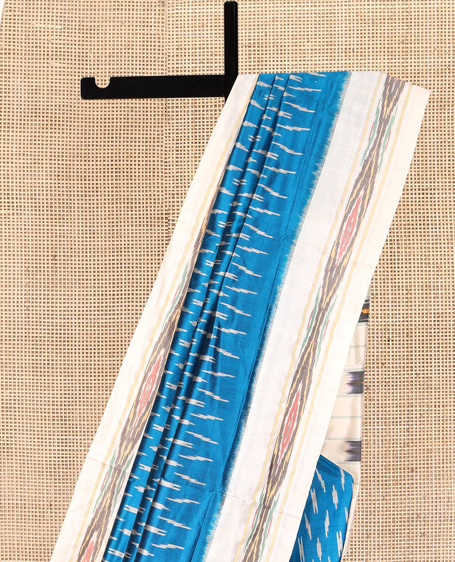 Blue Pochampally Ikat Silk Saree, Ornamented with Ikat Buttas, Complemented by a Contrast Ikat Border, Ikat-Style Pallu, and No Blouse