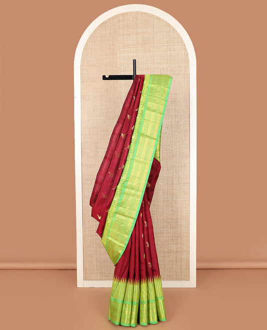 Maroon yaanai buttas Kanchipuram silk saree, contrast thazampoo rekku checked border of salngai, banaras, lavangam, and laddu kamalam designs, and floral design pallu