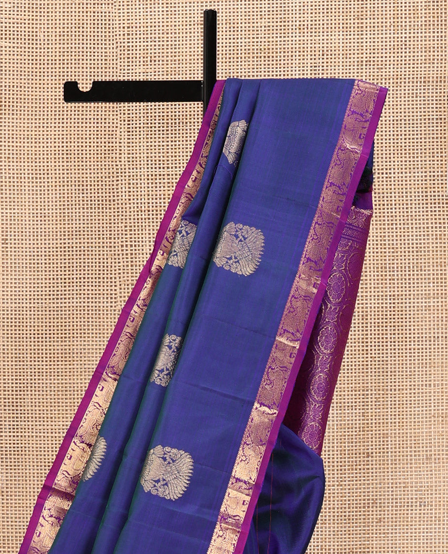 Blue Kanchipuram Silk Saree, Enthralled with Iruthalai Pakshi Buttas All Over Its Body, Complemented by Contrast Border of Rekku, Mayil, and Yaanai Designs, Pallu of Floral Jaal Designs, and Paired with a Contrast Blouse
