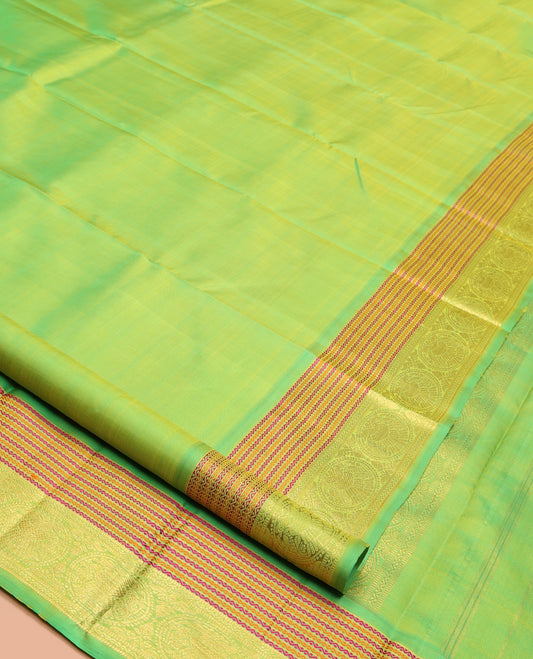 Green Plain Kanchipuram Silk Saree, Highlighted by Self-Border of Neli, and Round Iruthalai Pakshi Designs, Pallu of Same Design, and Paired with a Matching Blouse