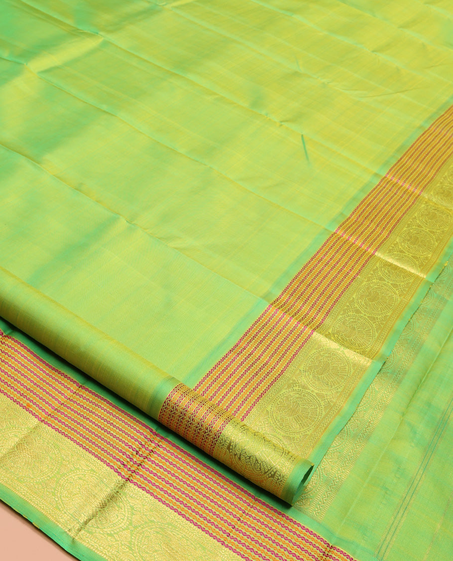 Green Plain Kanchipuram Silk Saree, Highlighted by Self-Border of Neli, and Round Iruthalai Pakshi Designs, Pallu of Same Design, and Paired with a Matching Blouse