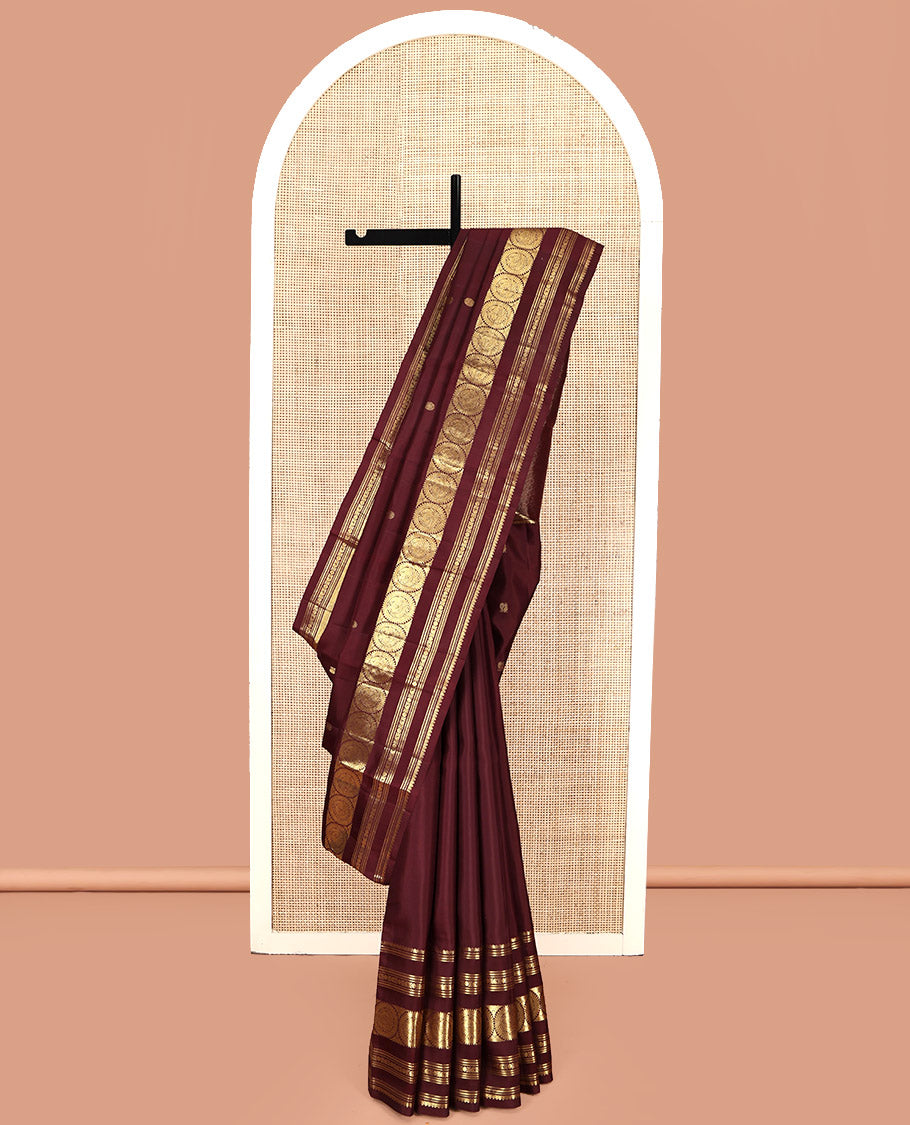 Maroon Kanchipuram Silk Saree, Crafted with Mayil and Chakram Buttas All Over Its Body, Highlighted by a Zari Border of Thilakam Mokku, Kathir, Kamalam, Manga, and Round Mayil Designs, Grand Jaal Pallu, and Paired with a Matching Blouse