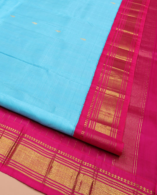 Blue Kanchipuram Silk Saree Bedecked with Zari Buttas, Highlighted by Contrast One-Sided Korvai Border of Paneer Sombu, Banaras, Muthu and Mayil Kann Designs, Pallu Elevated with Zari Design, and Comes Without a Blouse