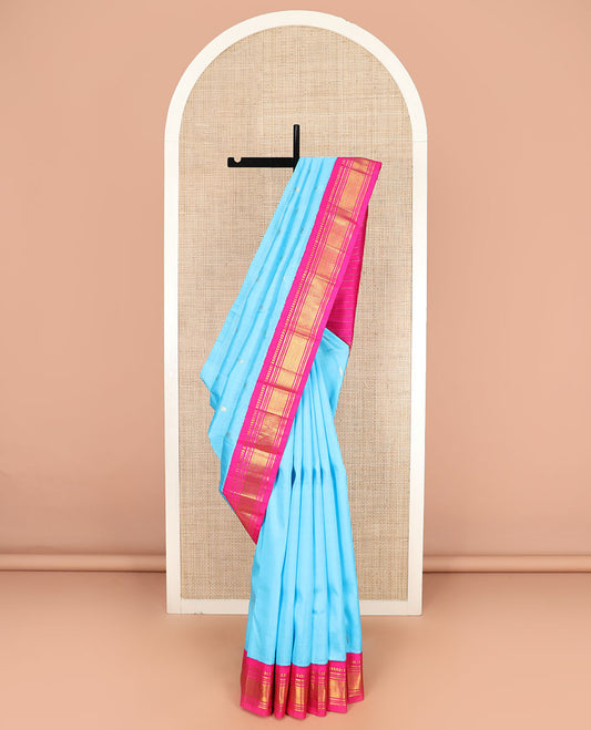 Blue Kanchipuram Silk Saree Bedecked with Zari Buttas, Highlighted by Contrast One-Sided Korvai Border of Paneer Sombu, Banaras, Muthu and Mayil Kann Designs, Pallu Elevated with Zari Design, and Comes Without a Blouse