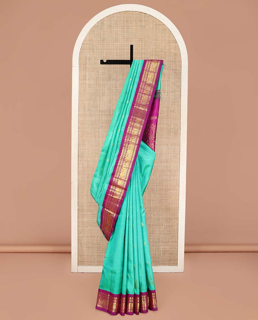 Blue Kanchipuram Silk Saree, Subtly Sparkled with Zari Buttas on Its Body, Complemented by a Contrast One-Sided Korvai Border of Rettai Neli, Banaras, and Floral Designs, Pallu of Paisley-Floral Designs, and Comes Without a Blouse