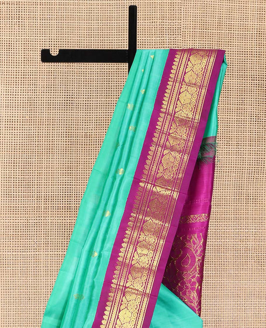 Blue Kanchipuram Silk Saree, Subtly Sparkled with Zari Buttas on Its Body, Complemented by a Contrast One-Sided Korvai Border of Rettai Neli, Banaras, and Floral Designs, Pallu of Paisley-Floral Designs, and Comes Without a Blouse