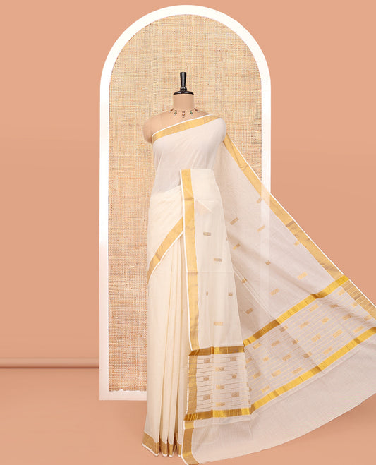 Cream Kerala Cotton Saree, Beautified with Zari Buttas All Over Its Body, a Subtle Bavanji Border, Pallu Features Stripes and Buttas, and Is Paired with a Matching Blouse