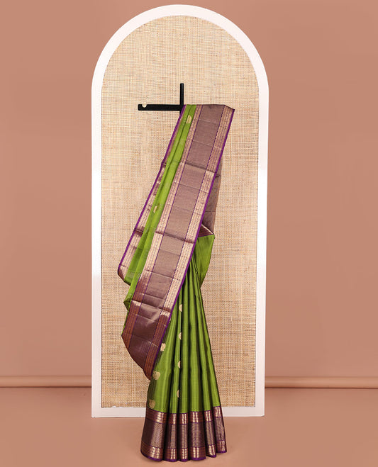 Green Mayuri Soft Silk Saree, Embellished with Mayil Chakram Buttas, Complemented by Contrast Border of Thilakam Mokku, Muthu, Kathir, and Laddu Kamalam Designs, Pallu of Mayil, Yaanai, and Rudraksham Designs, and Paired with Contrast Blouse