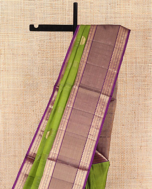 Green Mayuri Soft Silk Saree, Embellished with Mayil Chakram Buttas, Complemented by Contrast Border of Thilakam Mokku, Muthu, Kathir, and Laddu Kamalam Designs, Pallu of Mayil, Yaanai, and Rudraksham Designs, and Paired with Contrast Blouse
