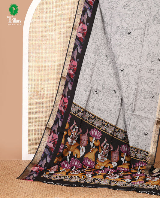 Grey kalamkari-style cow, lotus & human motifs printed Assam cotton saree, contrast floral print & zari paisley border & printed blouse