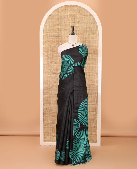 Black-base plain body khadi cotton saree with batik-style green-color radiant sunburst design on its border & pallu, plain black blouse