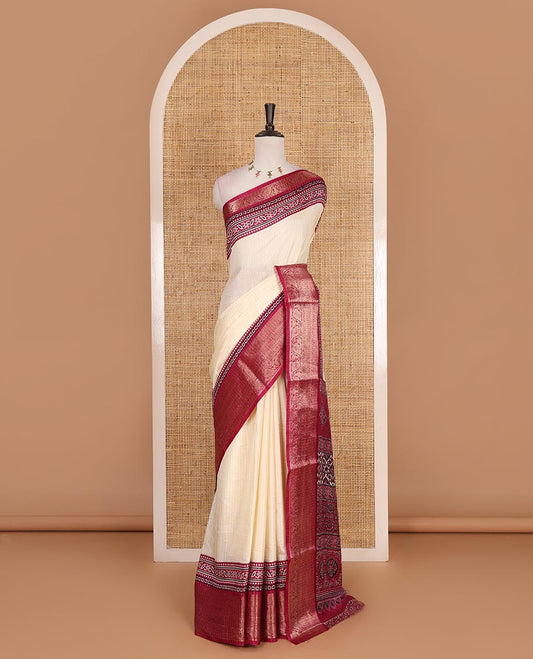 Cream-magenta zari striped dola silk saree, contrast traditional zari border of leaf creeper, Ajrakh printed pallu, and Ajrakh printed blouse