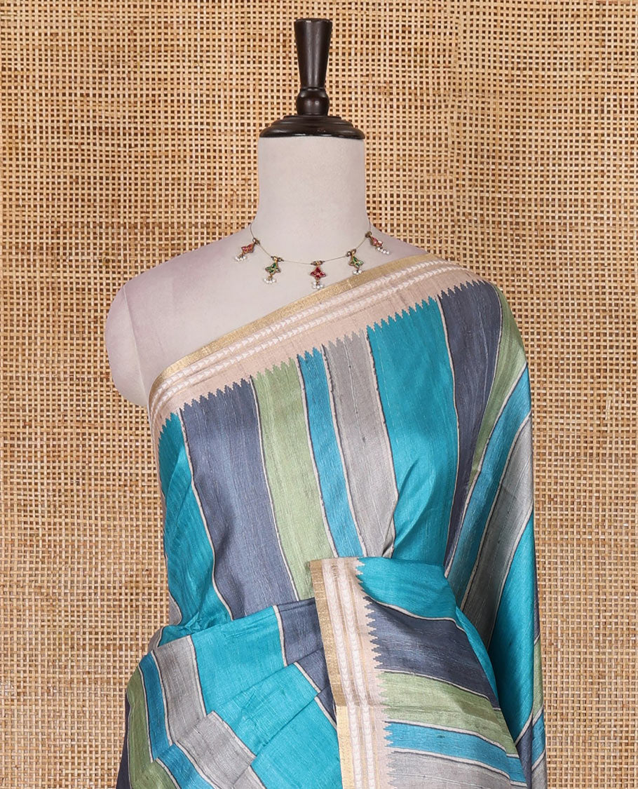Multi color vertically striped semi-tussar saree, contrast resham thread border of temple and rudraksham motifs, striped pallu, and contrast striped printed blouse