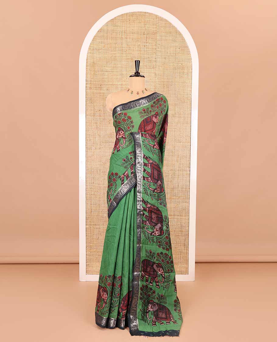 Green plain muslin cotton saree, contrast wedding-theme of floral and elephant motifs print, printed pallu, and a contrast buttas and zari bordered blouse