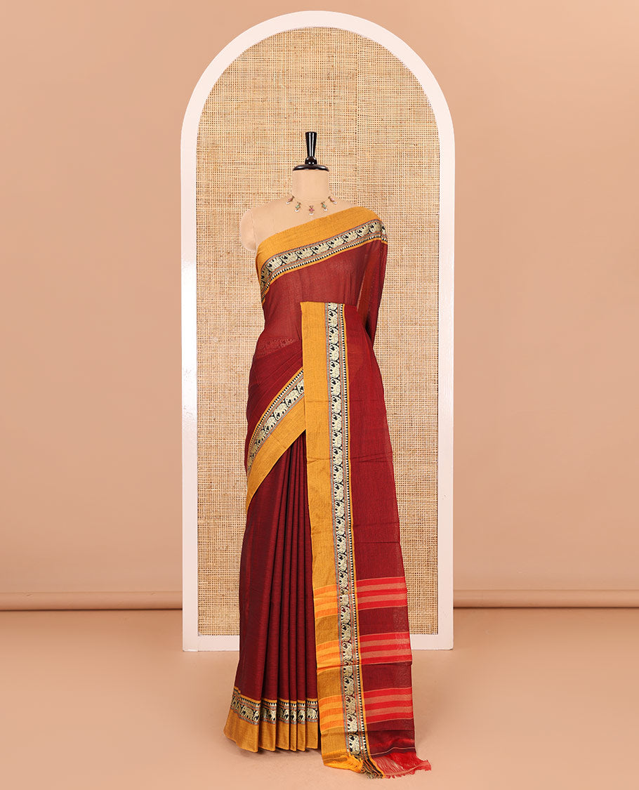 Maroon plain mercerised cotton saree, contrast kal erangina thread border of elephant motifs, striped pallu, and a matching blouse